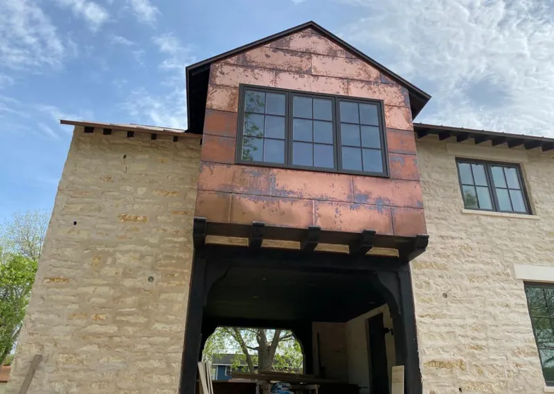 Copper metal panel facade on a stone building for Skylight Installation in Culpeper